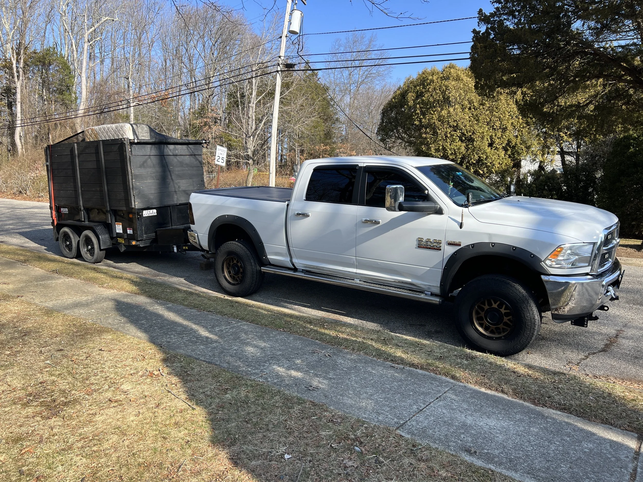 S&F Home Improvement white RAM truck with black dump trailer